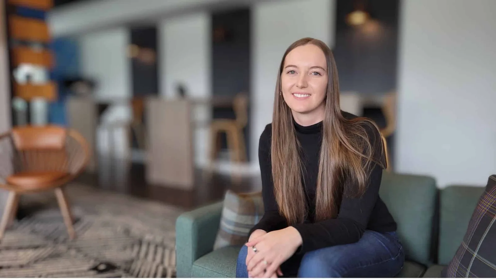 Taylor Smith, founder of Evolving Money, seated in a bright lounge